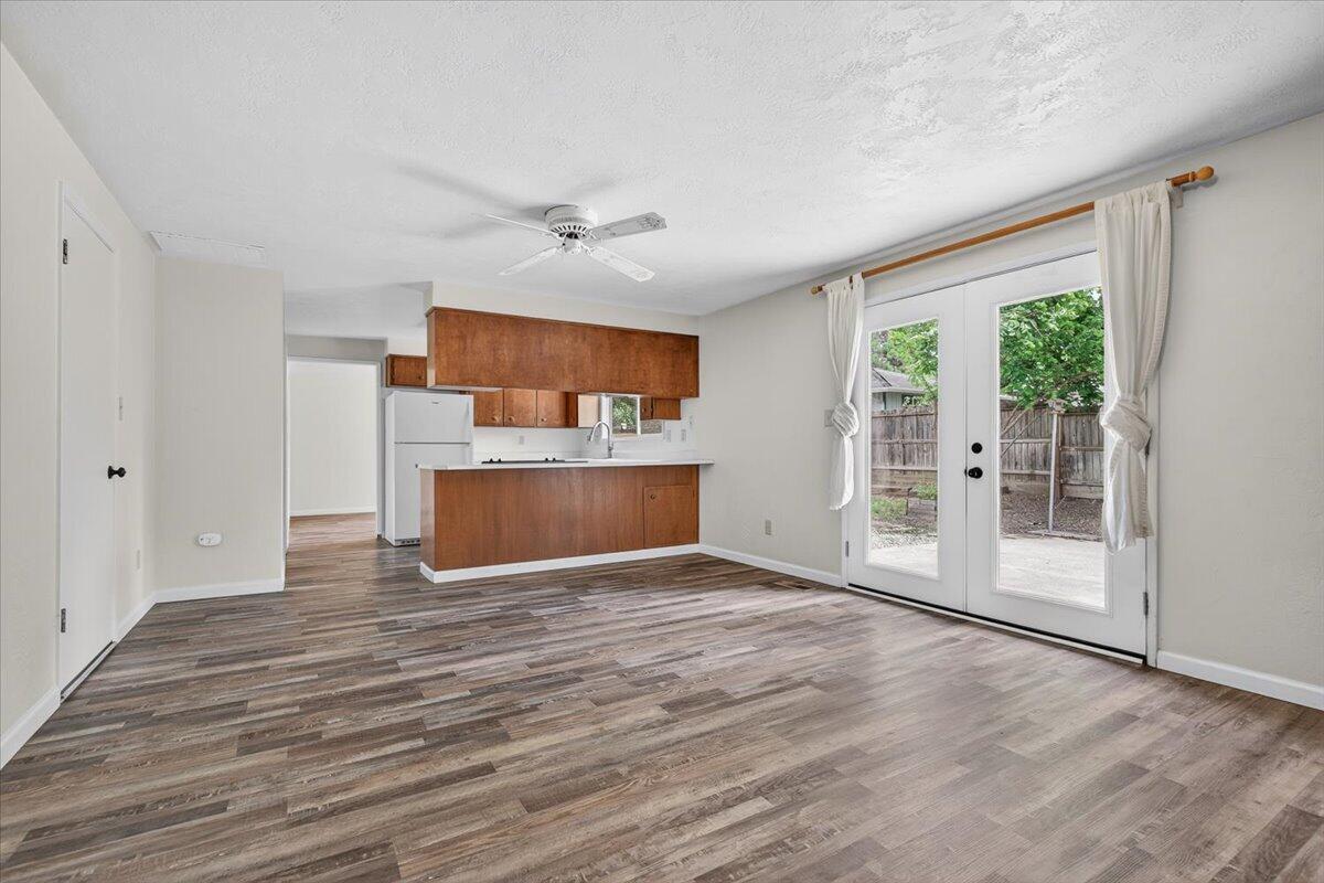 415 Sutter Avenue Medford, OR 97504 - Photo 13 of 28 a view of empty room with wooden floor and fireplace