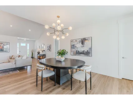 a dining room with furniture window and wooden floor