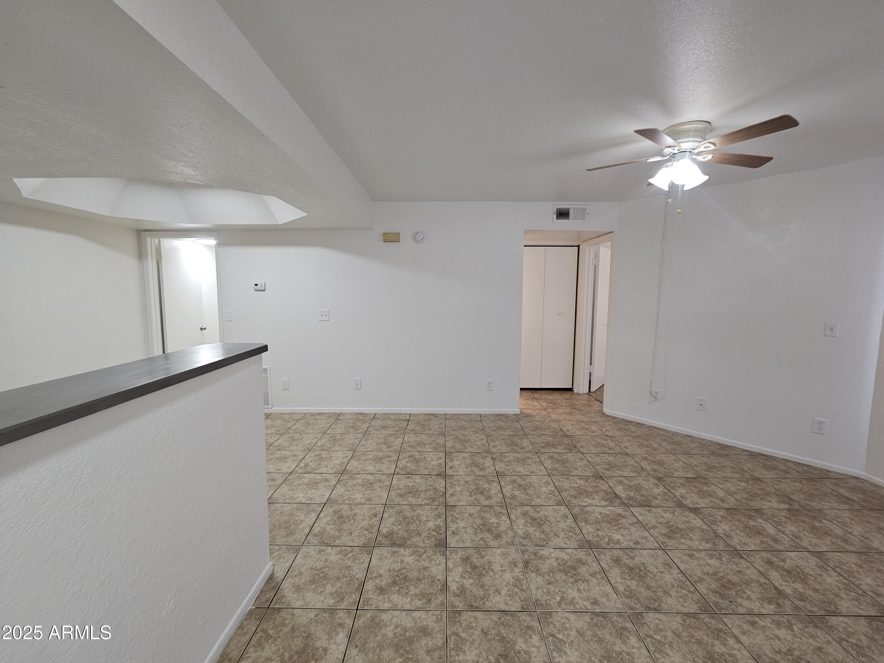 1370 South Price Road, Unit 115 Tempe, AZ 85281 - Photo 1 of 14 a view of a livingroom with a ceiling fan and window