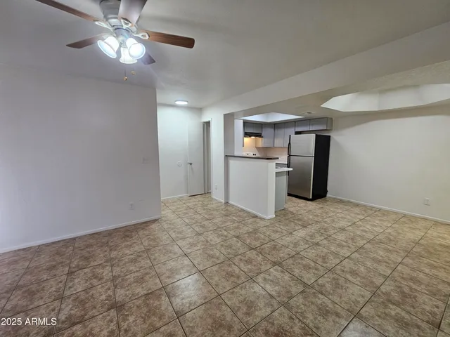 a view of a kitchen with a sink and a refrigerator