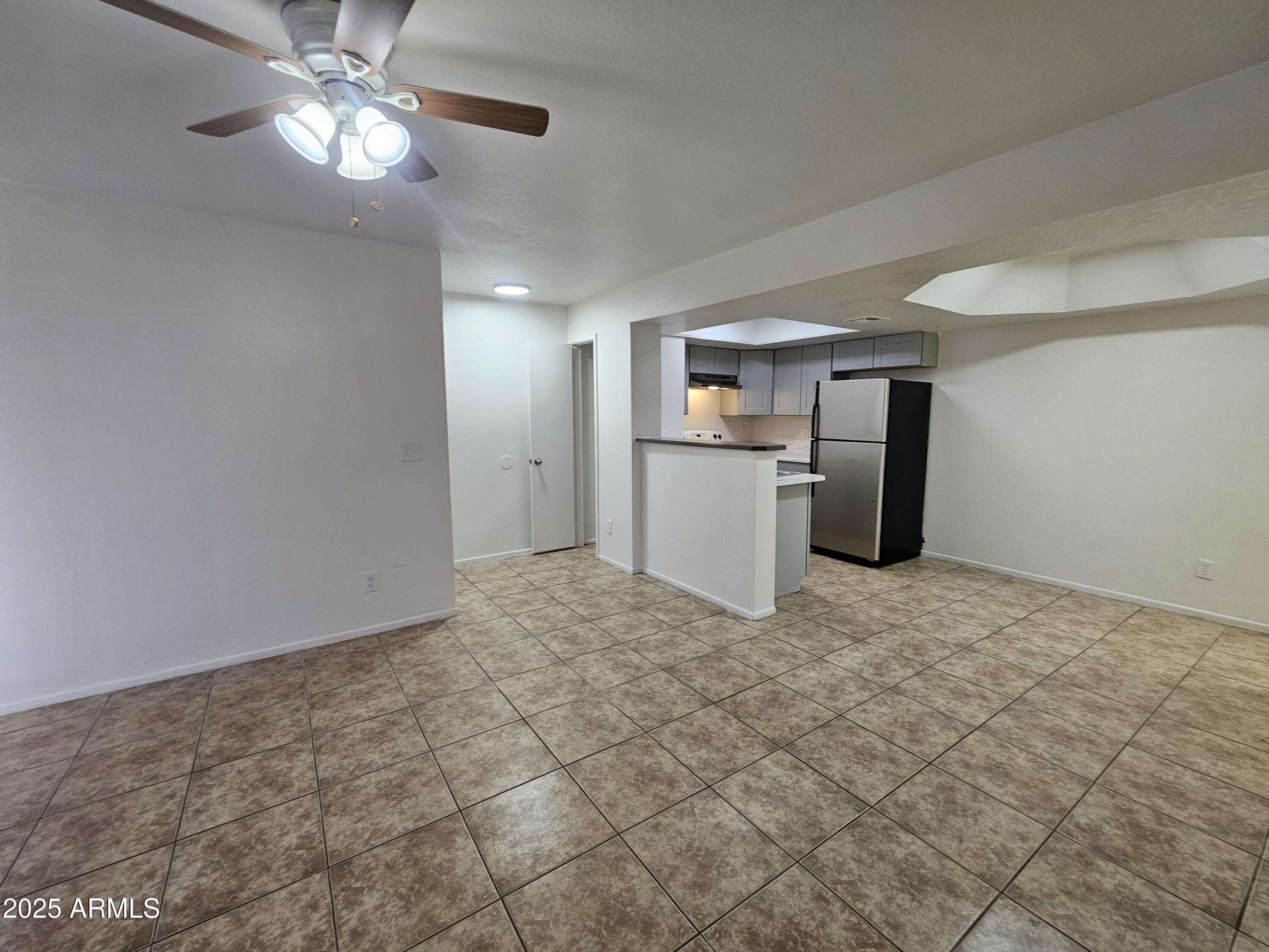 1370 South Price Road, Unit 115 Tempe, AZ 85281 - Photo 12 of 14 a view of a kitchen with a sink and a refrigerator