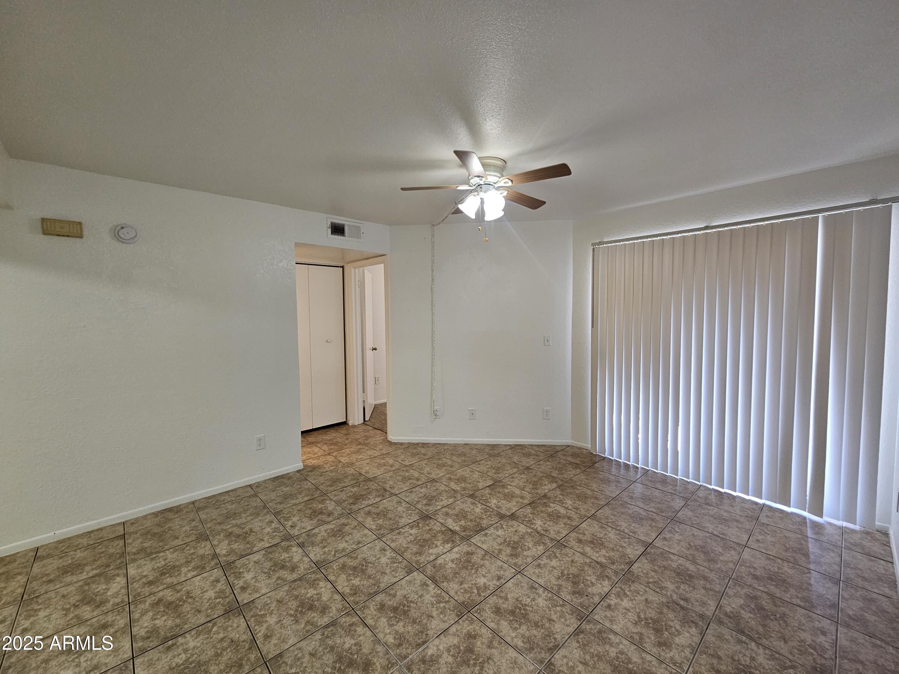 1370 South Price Road, Unit 115 Tempe, AZ 85281 - Photo 2 of 14 a view of an empty room with a ceiling fan
