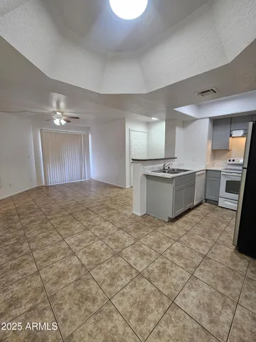a large kitchen with cabinets and stainless steel appliances