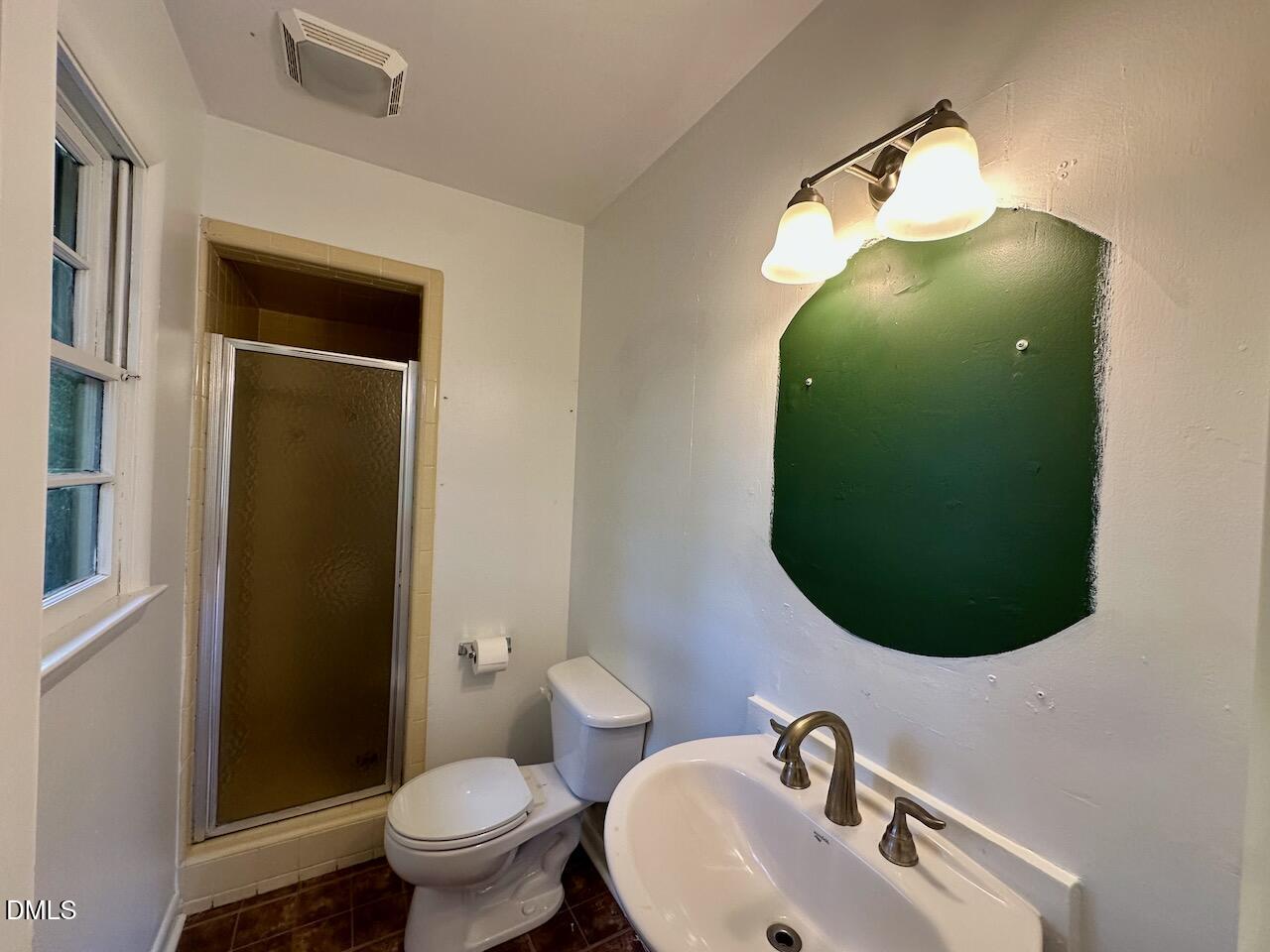 3421 Huntleigh Drive Raleigh, NC 27604 - Photo 14 of 27 a bathroom with a sink mirror and toilet