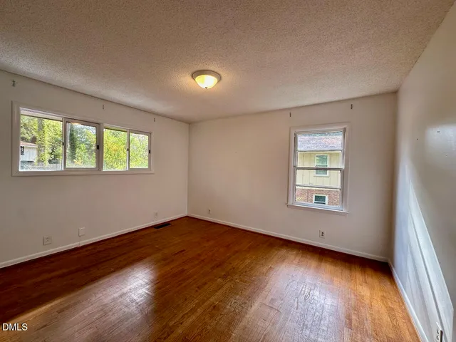 a bathroom with a toilet a sink a mirror and vanity