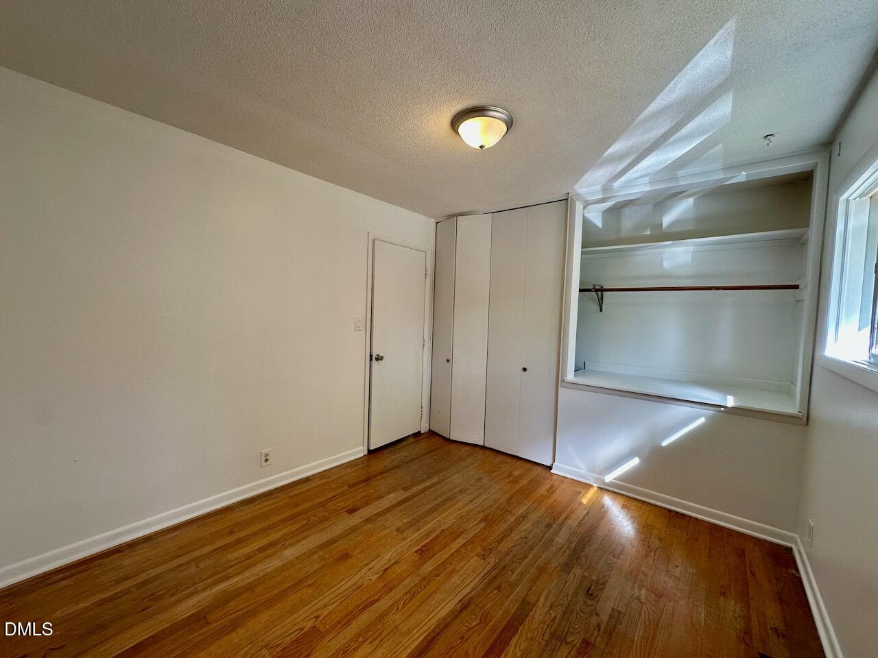 3421 Huntleigh Drive Raleigh, NC 27604 - Photo 18 of 27 a view of empty room with wooden floor