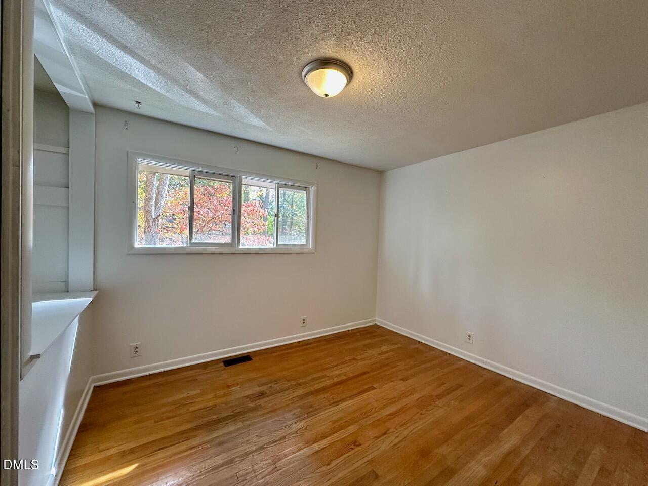 3421 Huntleigh Drive Raleigh, NC 27604 - Photo 19 of 27 a view of empty room with wooden floor
