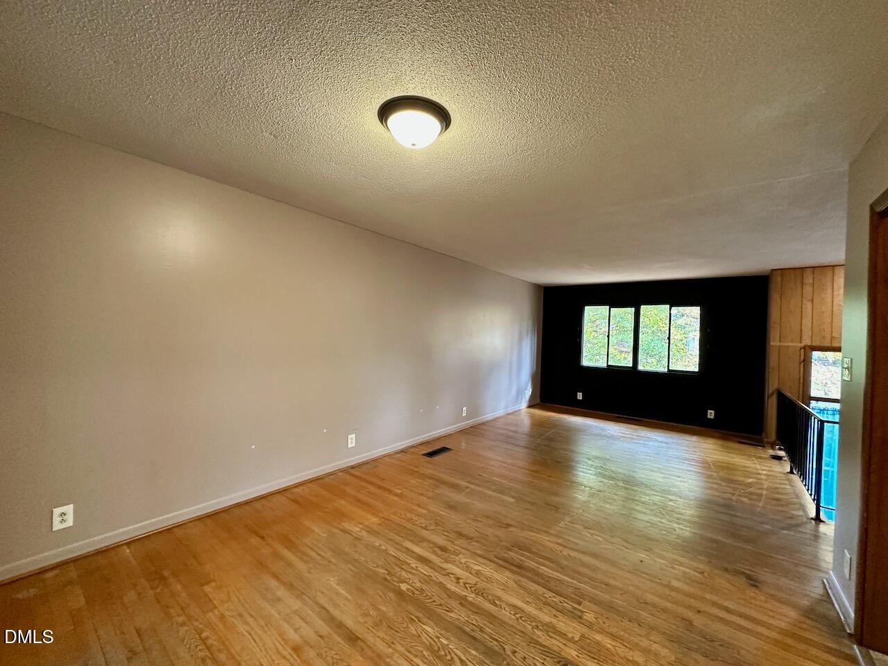 3421 Huntleigh Drive Raleigh, NC 27604 - Photo 9 of 27 an empty room with wooden floor and windows