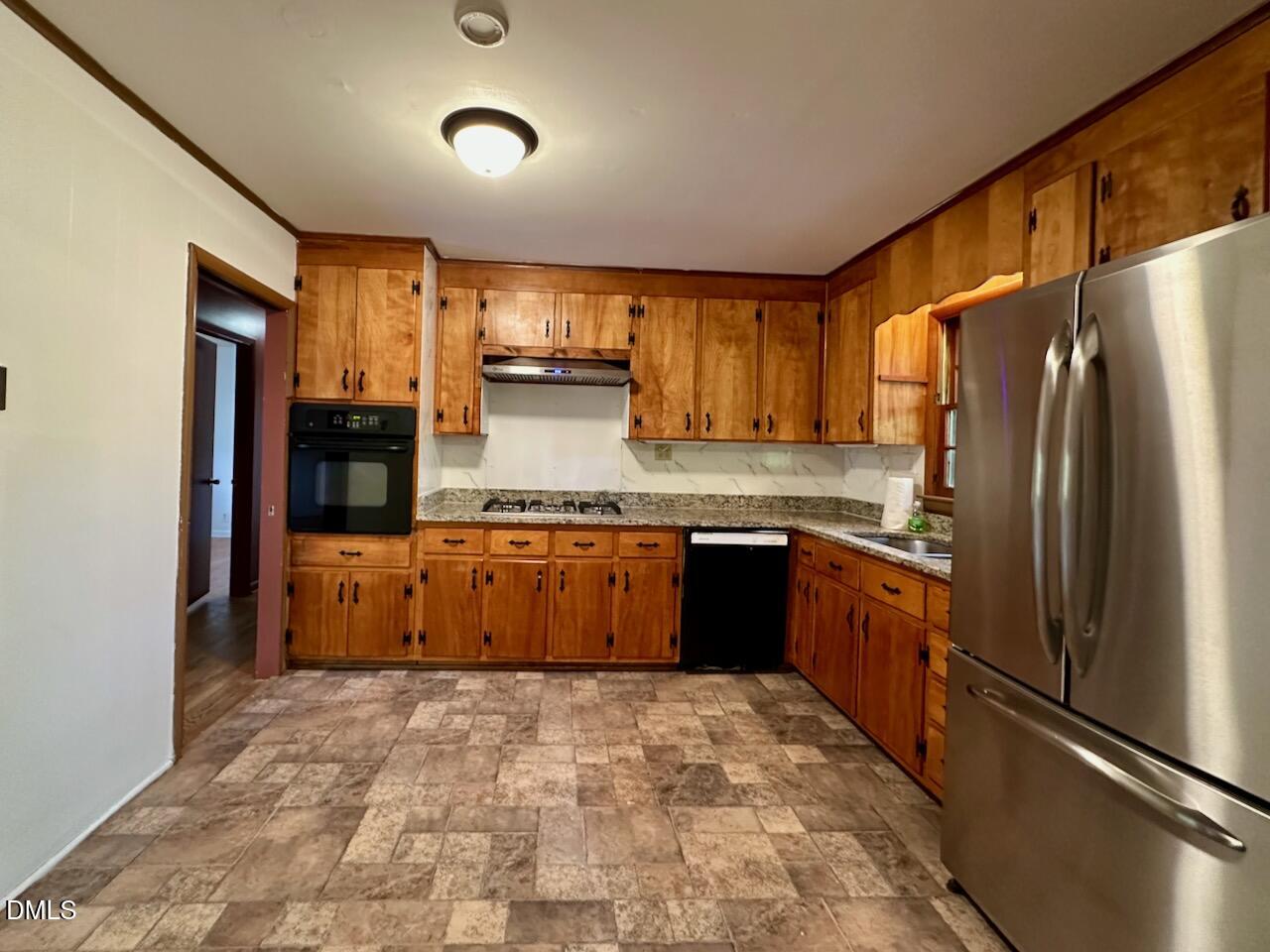 3421 Huntleigh Drive Raleigh, NC 27604 - Photo 10 of 27 a kitchen with stainless steel appliances granite countertop a refrigerator and a sink
