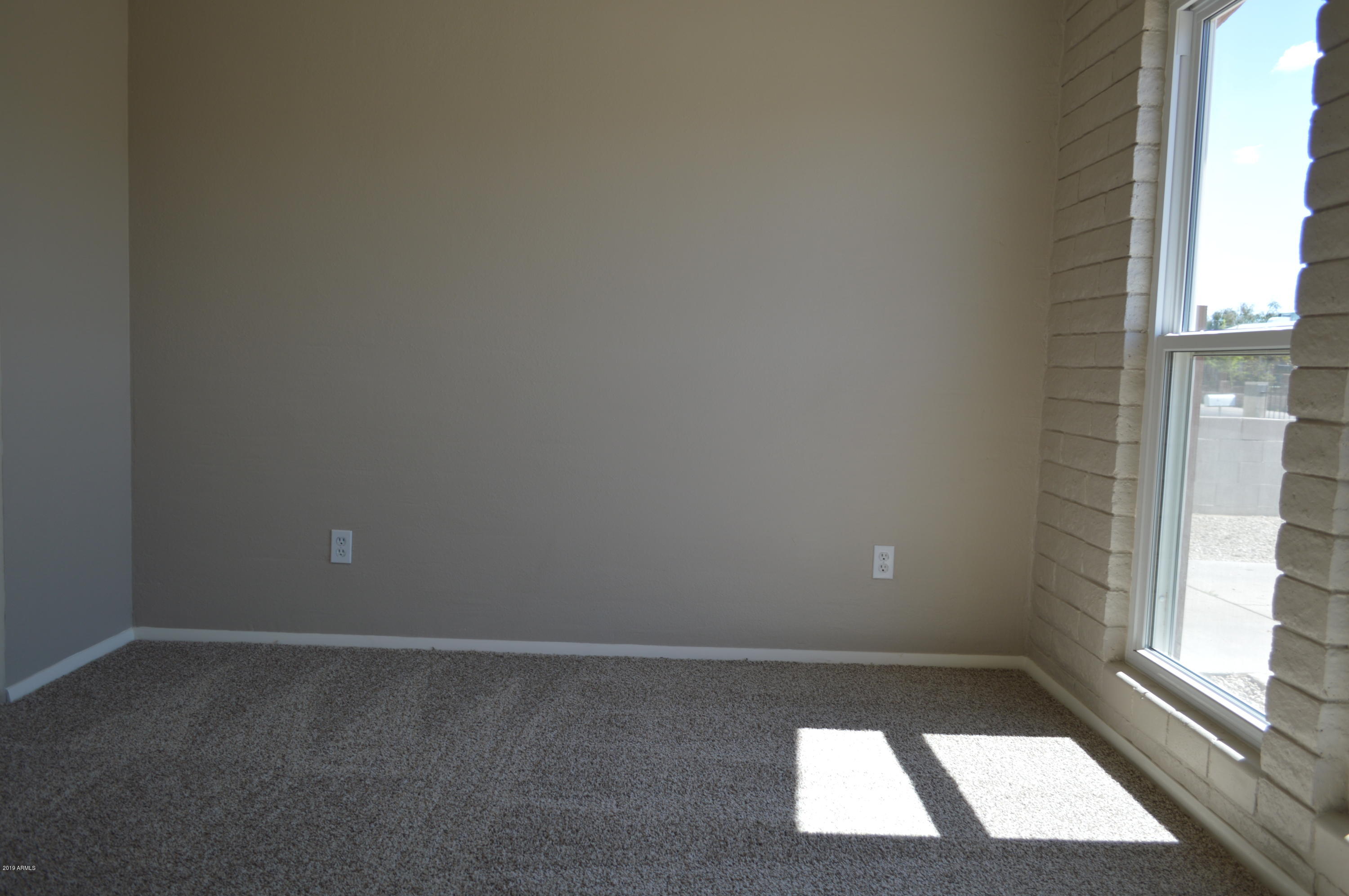 1602 West Darrel Road Phoenix, AZ 85041 - Photo 18 of 39 a view of an empty room with a window