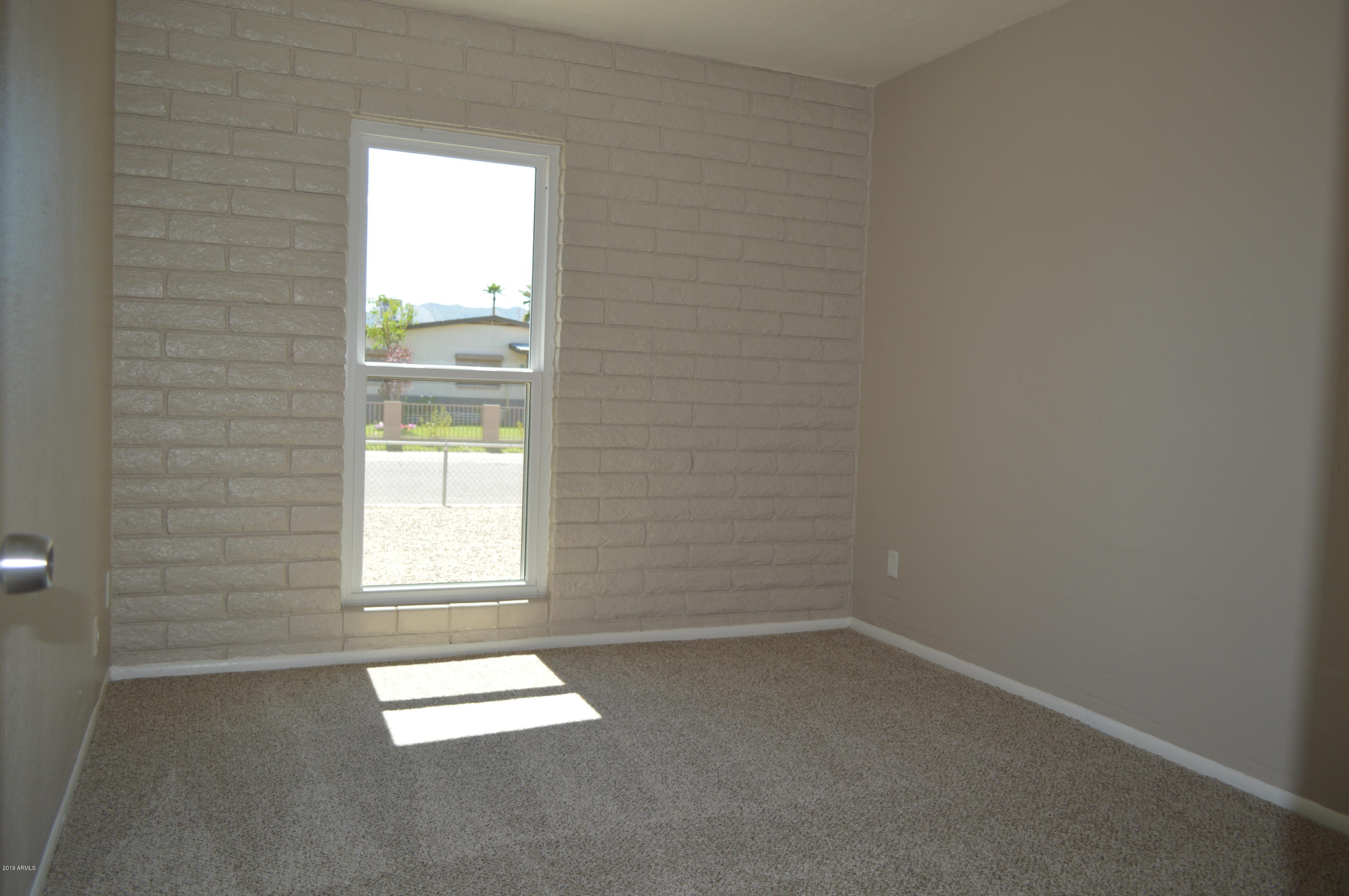 1602 West Darrel Road Phoenix, AZ 85041 - Photo 23 of 39 an empty room with a window
