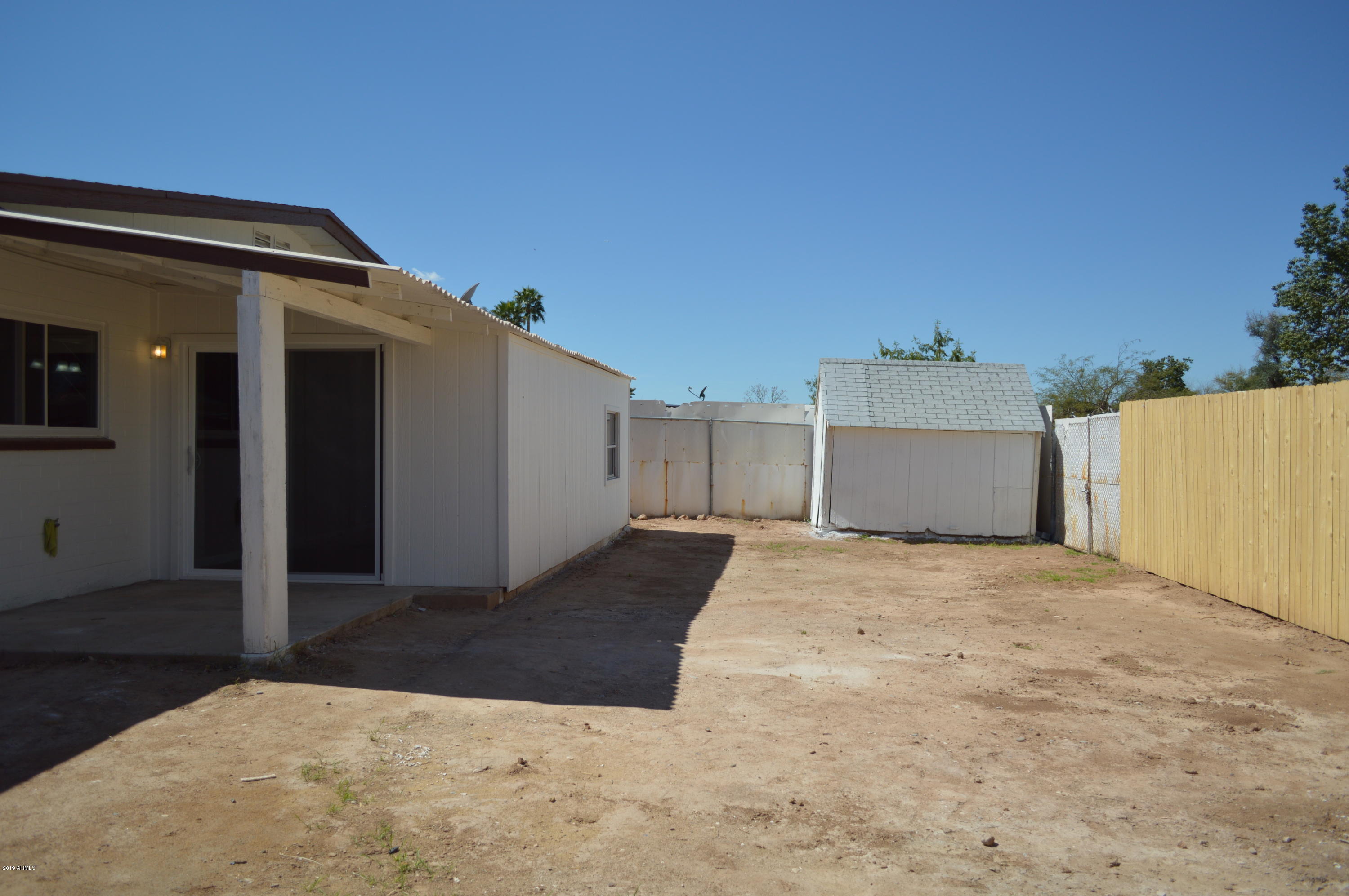 1602 West Darrel Road Phoenix, AZ 85041 - Photo 35 of 39 a view of a house with a yard and garage