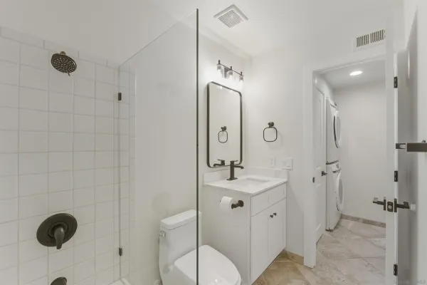 a bathroom with a double vanity sink mirror and shower