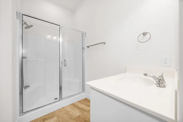 a bathroom with a sink and shower