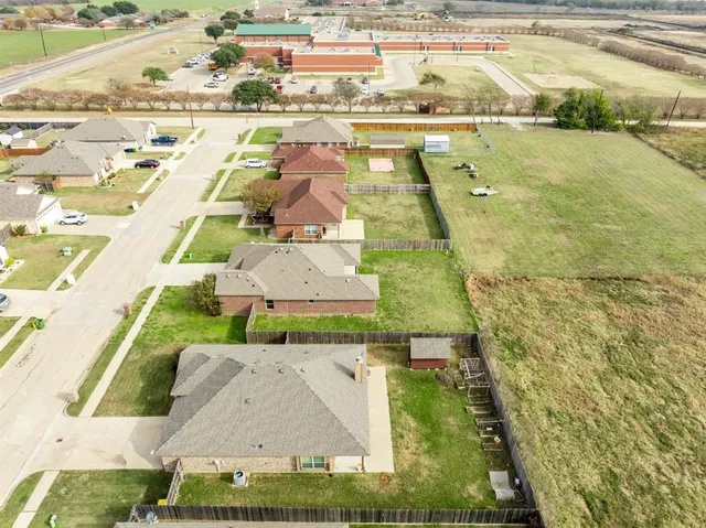 an aerial view of residential houses with outdoor space
