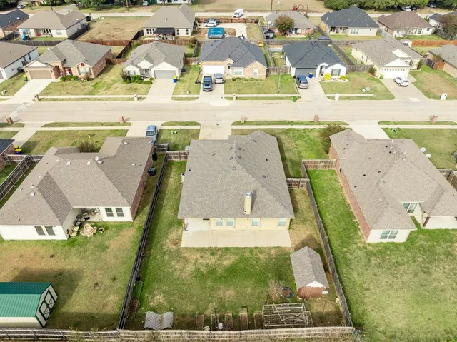 an aerial view of residential houses with outdoor space