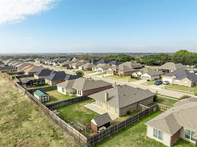 a view of a house with pool and chairs