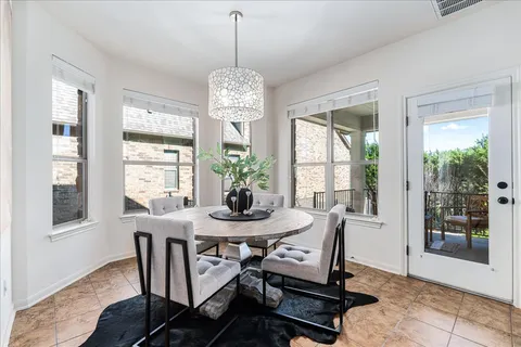 a view of a dining room with furniture wooden floor and chandelier