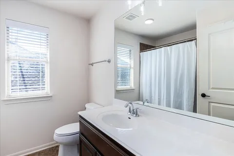 a bathroom with a sink toilet and shower