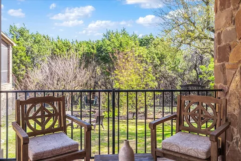 a view of a balcony with wooden floor and outdoor seating