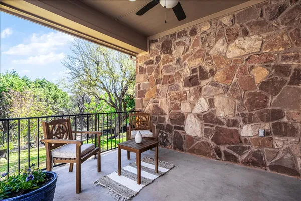 a view of a chairs and table in the balcony