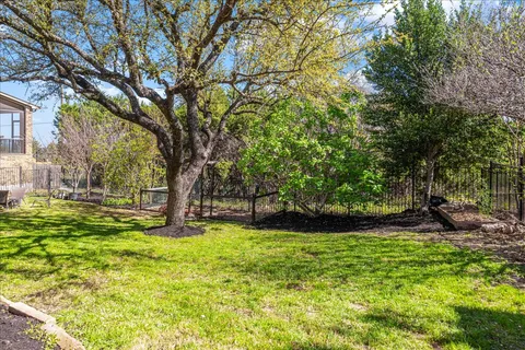 a view of a backyard with large trees