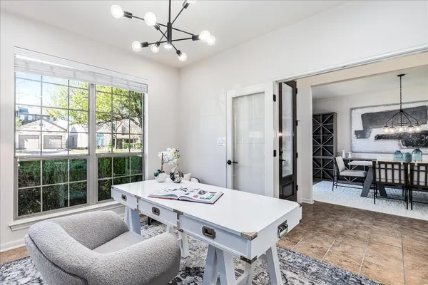 a living room with furniture a table and a large window