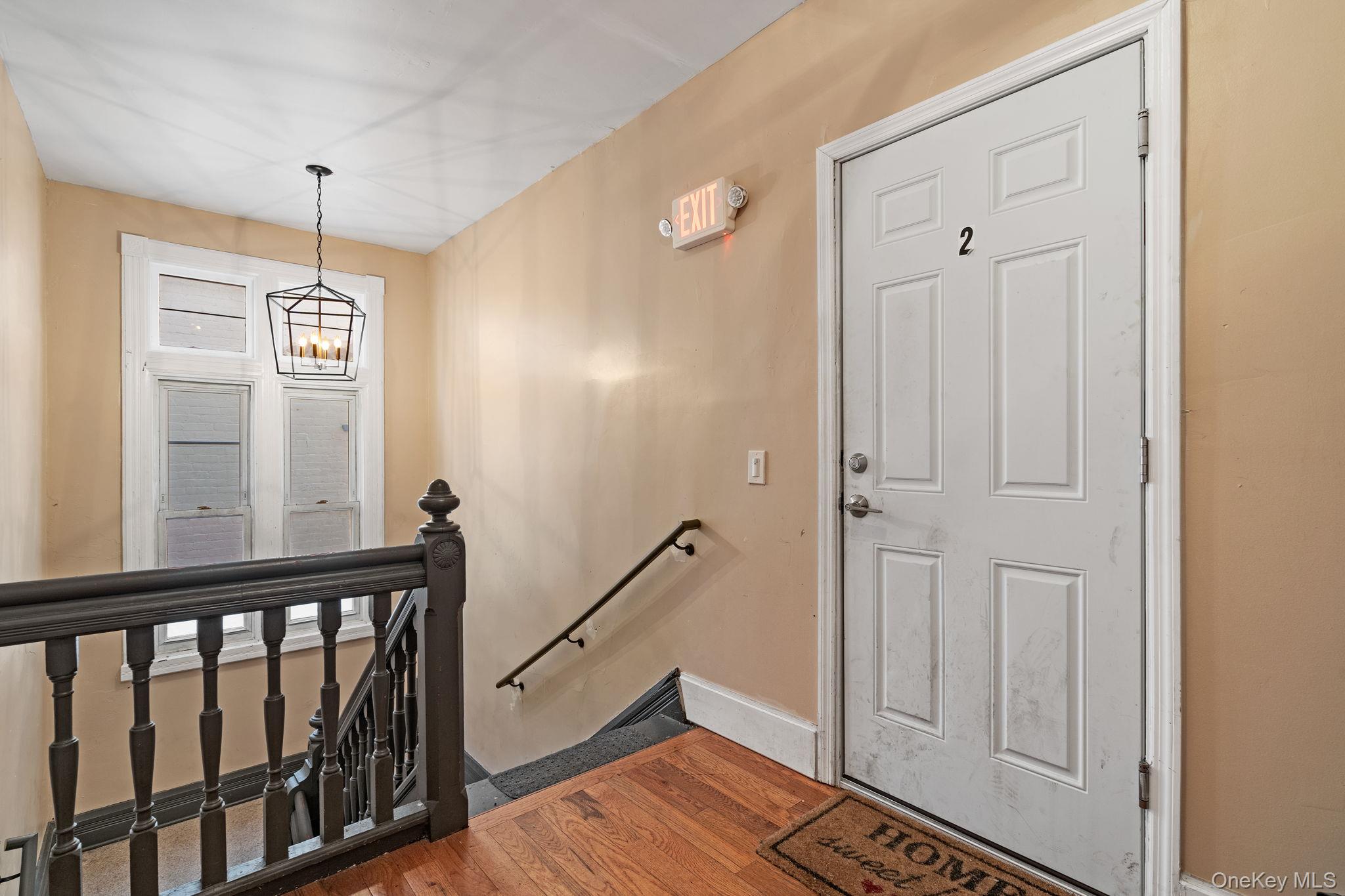 77 Academy Street Poughkeepsie, NY 12601 - Photo 21 of 30 Entrance foyer with a chandelier and wood finished floors