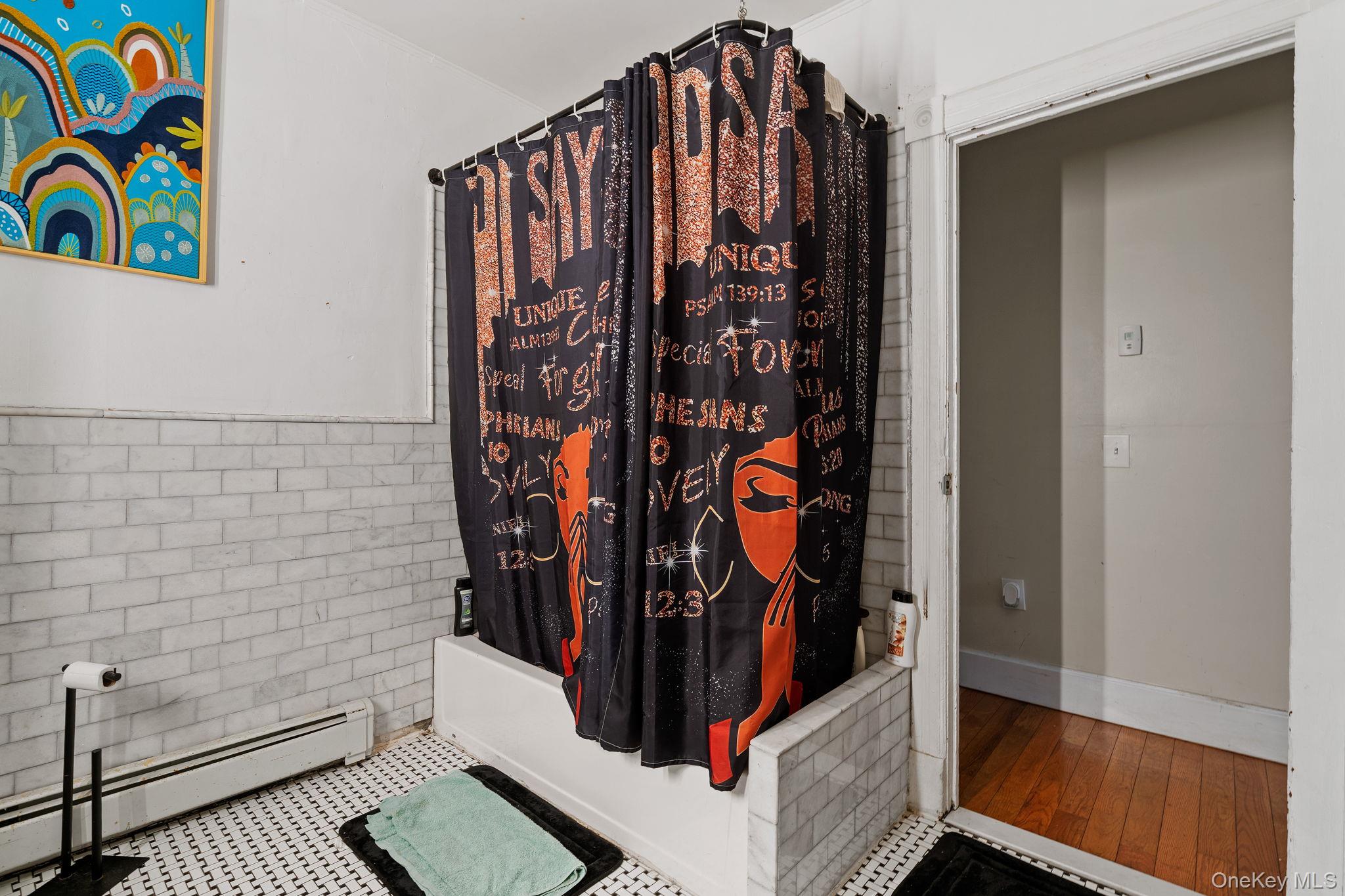 77 Academy Street Poughkeepsie, NY 12601 - Photo 23 of 30 Full bath with a baseboard heating unit and shower / bath combination with curtain