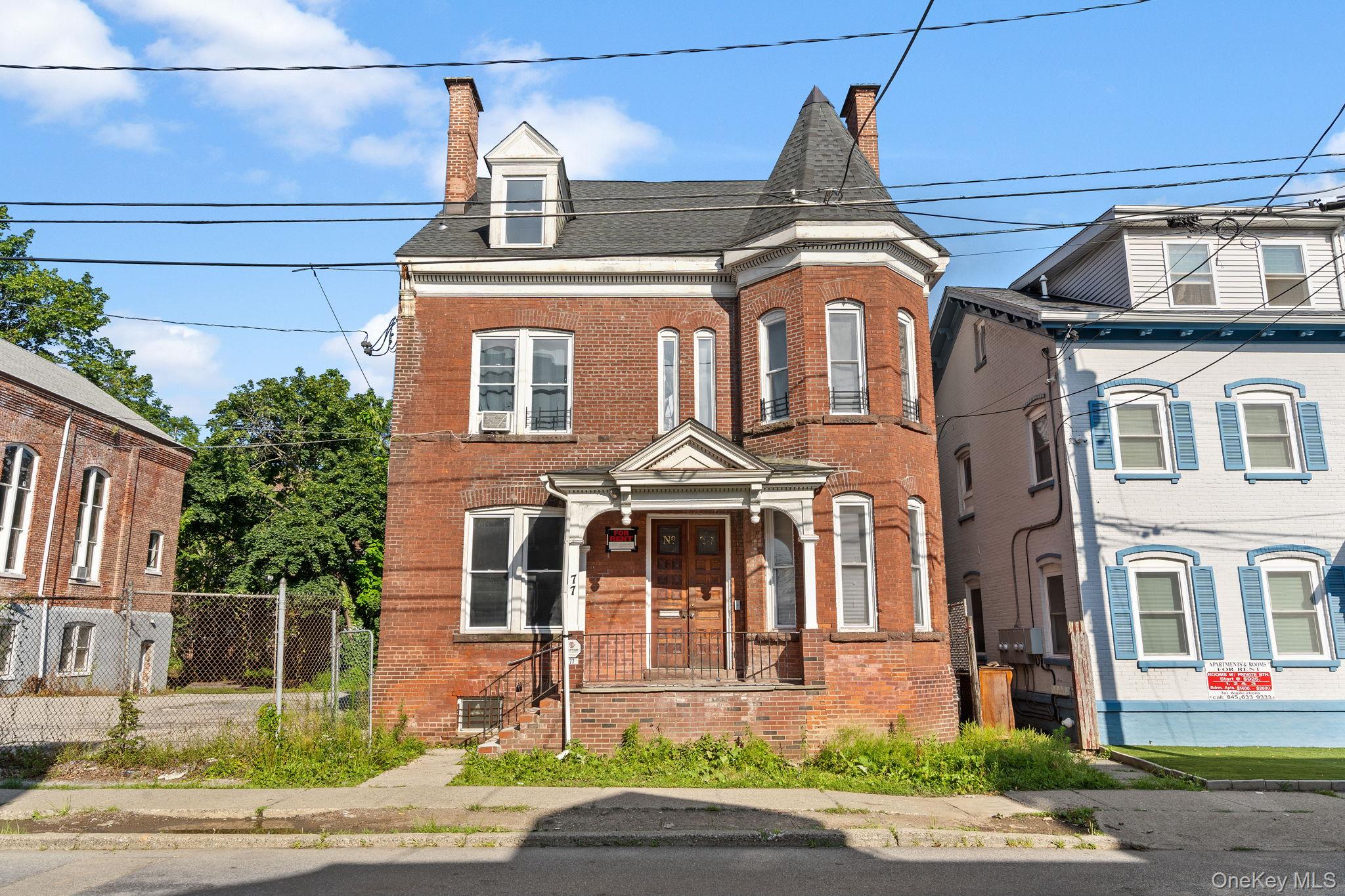 77 Academy Street Poughkeepsie, NY 12601 - Photo 4 of 30 View of front of house with a chimney, brick siding, and a shingled roof