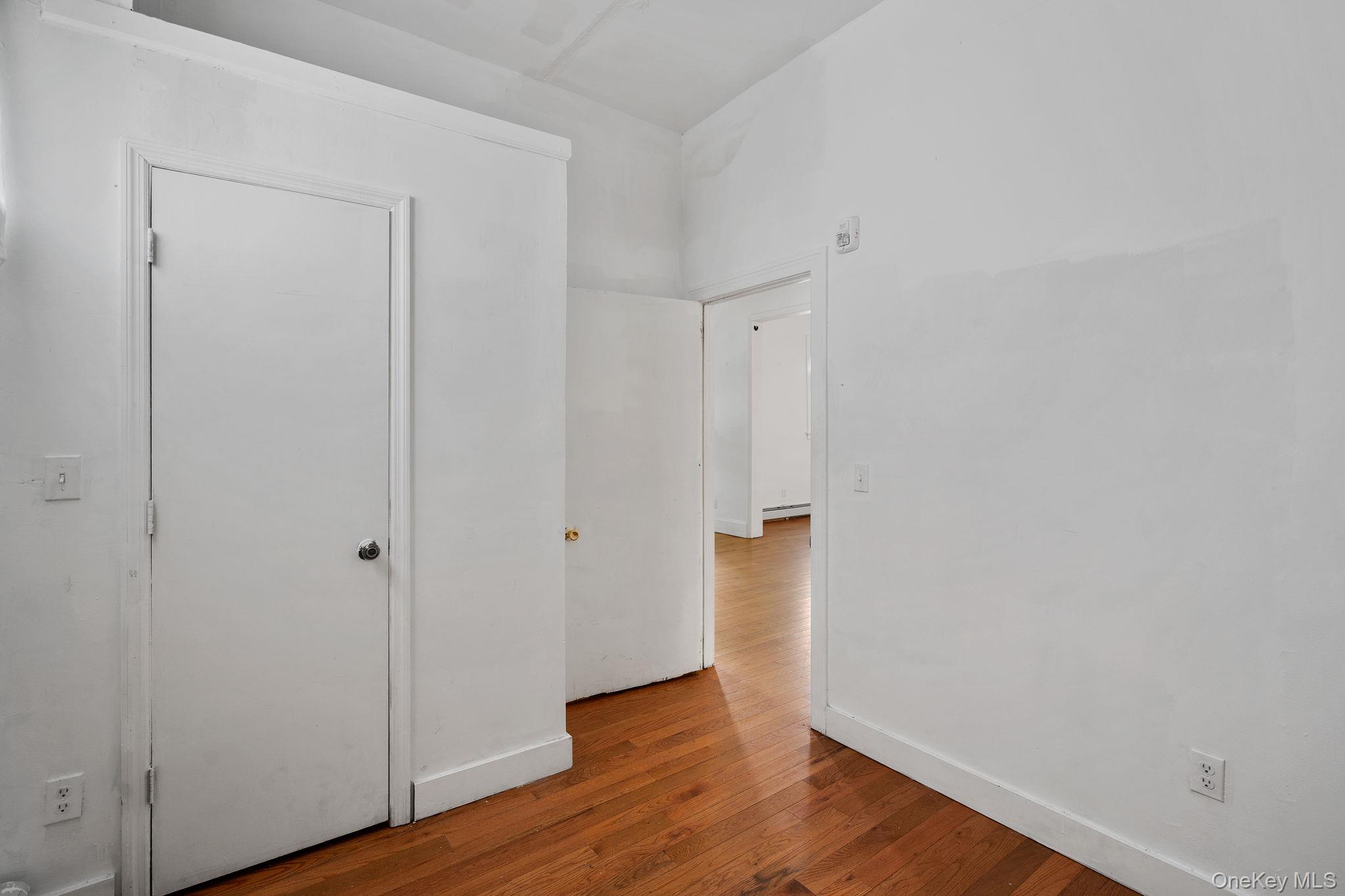 77 Academy Street Poughkeepsie, NY 12601 - Photo 10 of 30 Unfurnished bedroom with wood finished floors and baseboards