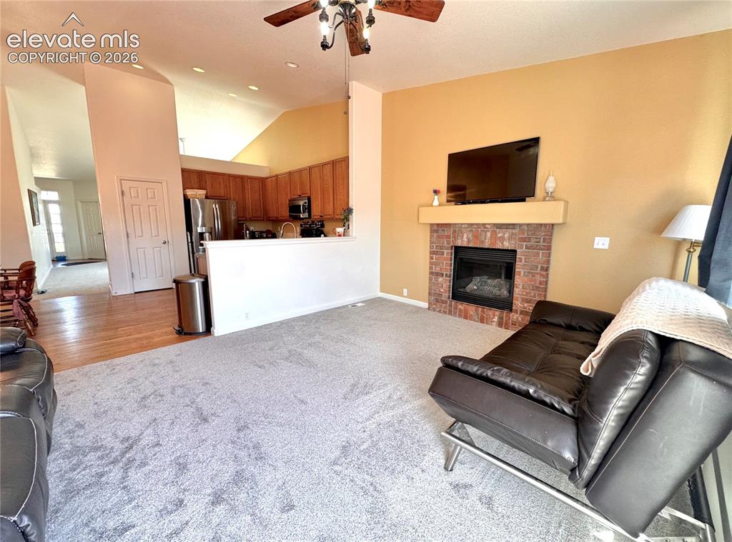 9362 St.George Road Peyton, CO 80831 - Photo 9 of 32 a living room with furniture and a fireplace