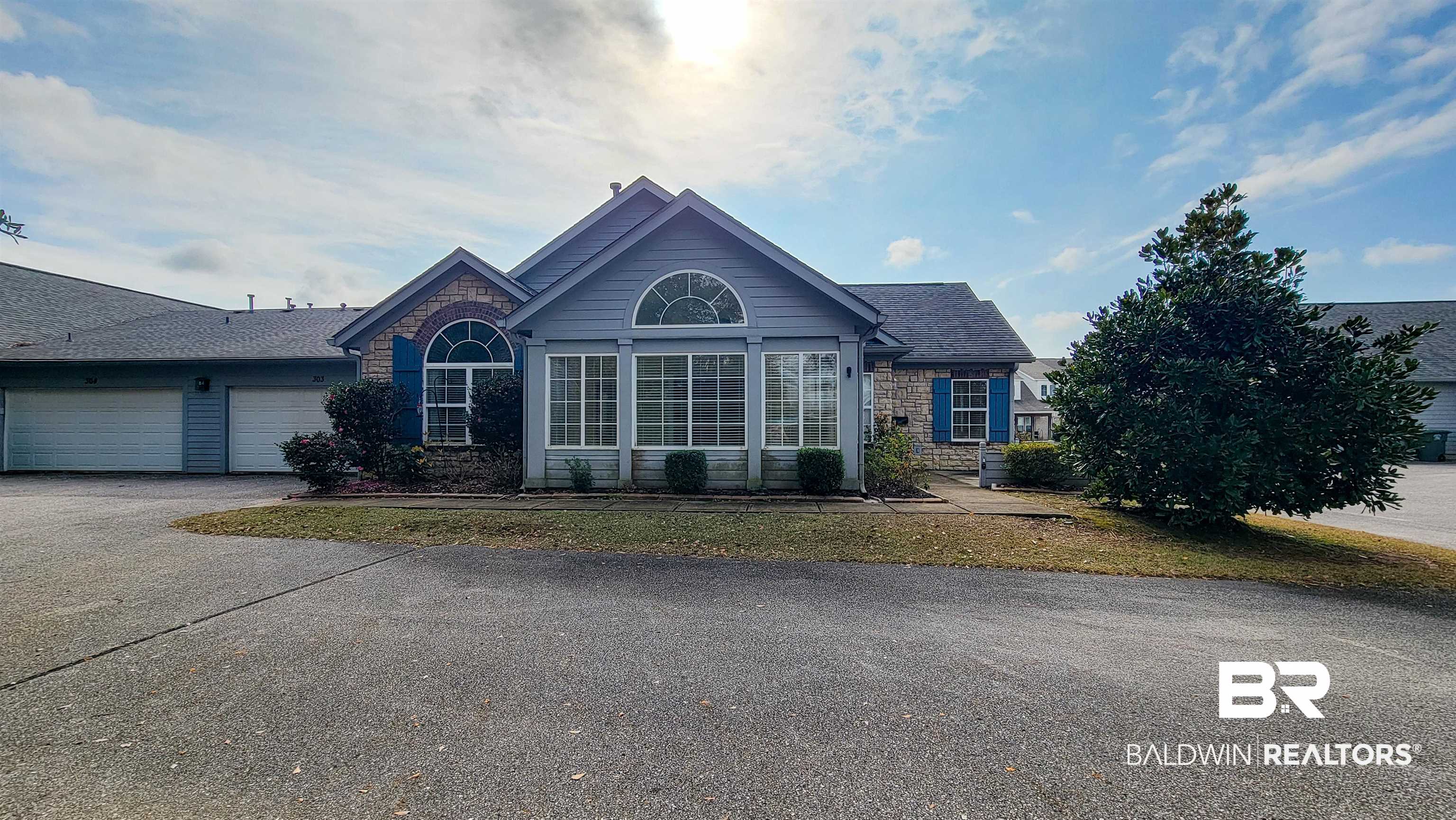 303 Wyld Palms Drive, Unit 303 Foley, AL 36535 - Photo 4 of 36 Single story home featuring asphalt driveway, a garage, and stone siding