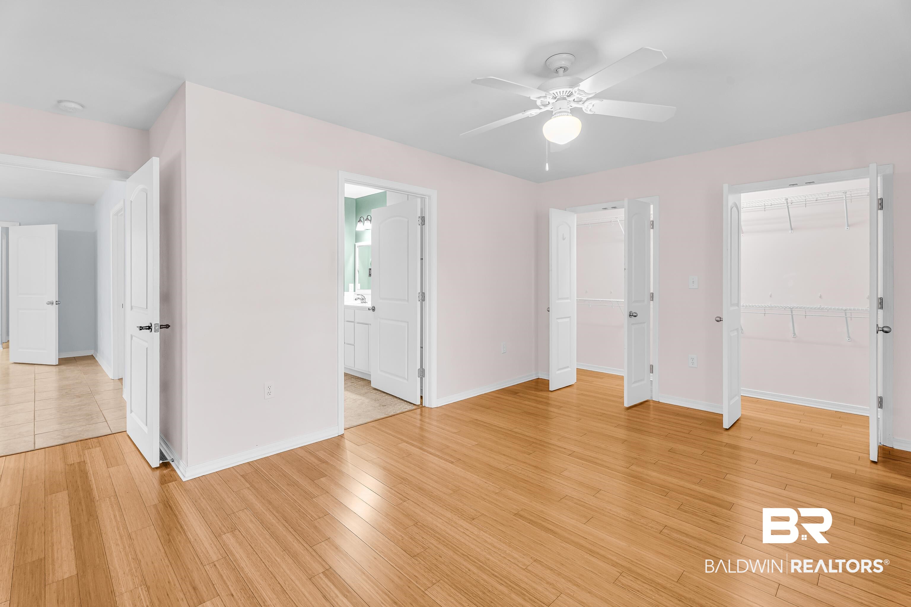 22095 8th Street Silverhill, AL 36576 - Photo 34 of 42 Unfurnished bedroom featuring a closet, a ceiling fan, and light wood-style floors