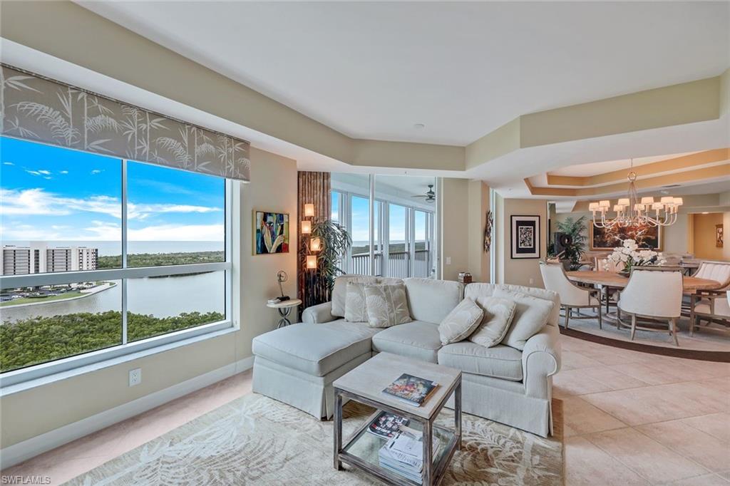 295 Grande Way, Unit 1202 Naples, FL 34110 - Photo 5 of 36 a living room with furniture or outdoor view and a large window