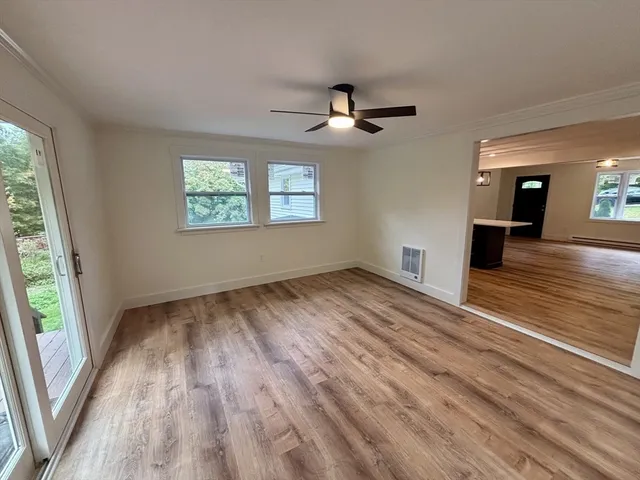 wooden floor in an empty room with a window