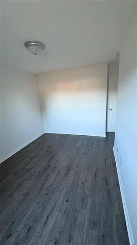 a view of a room with wooden floor and bench