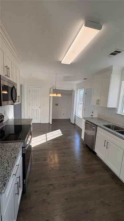 1289 Huntly Circle Thomson, GA 30824 - Photo 6 of 20 a large kitchen with stainless steel appliances granite countertop a lot of counter space and wooden floor