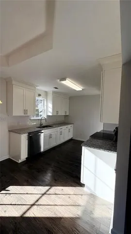 a kitchen with stainless steel appliances kitchen island granite countertop a sink and cabinets