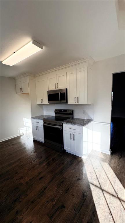 1289 Huntly Circle Thomson, GA 30824 - Photo 8 of 20 a kitchen with granite countertop a stove a sink and a microwave