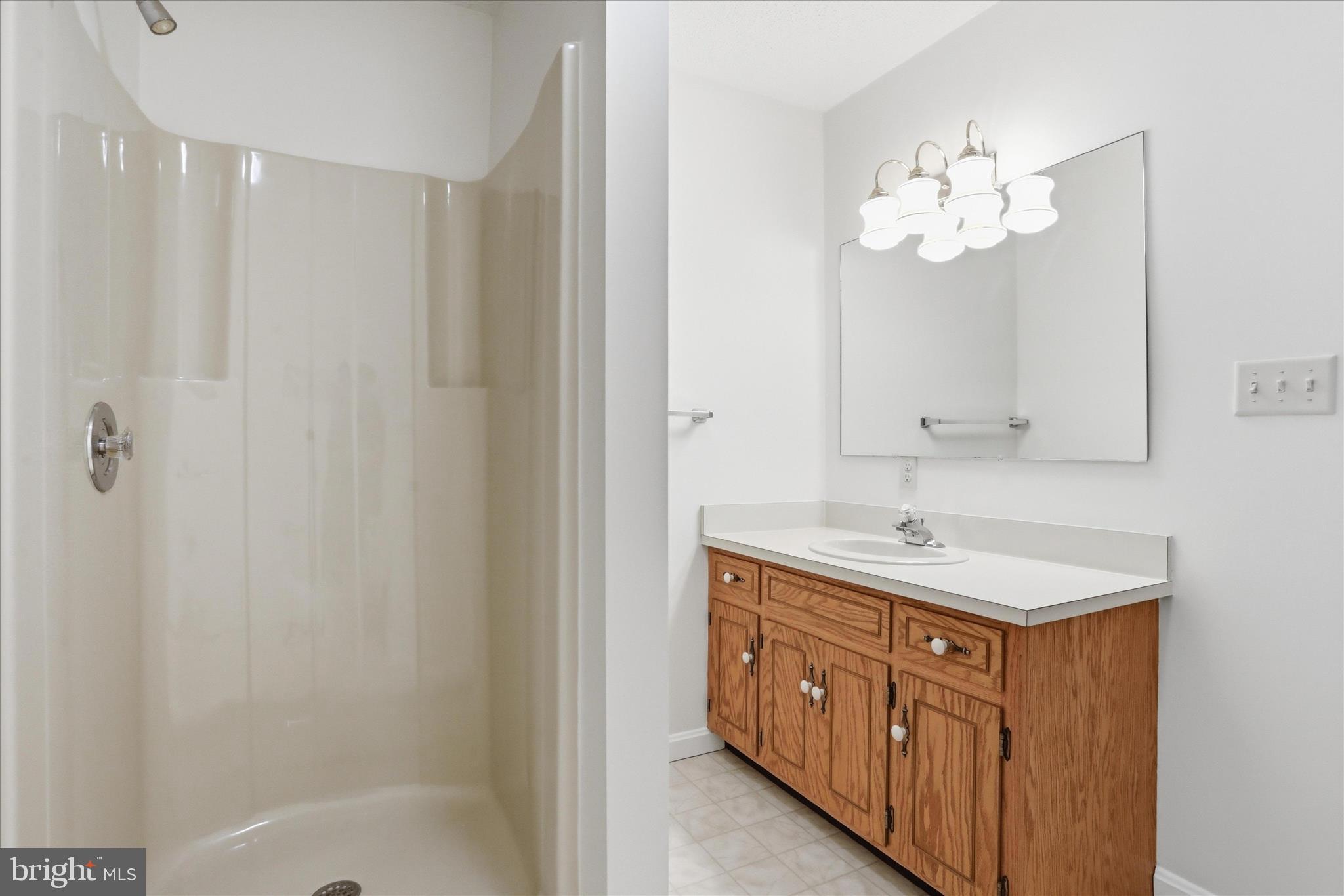 334 Stonegate Court Chambersburg, PA 17201 - Photo 21 of 25 a bathroom with a granite countertop sink a mirror and a bathtub