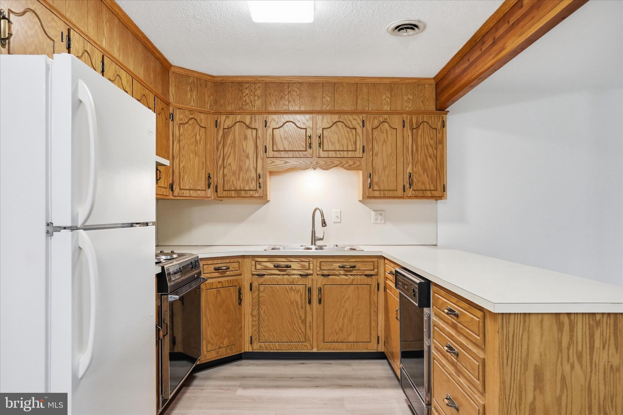 334 Stonegate Court Chambersburg, PA 17201 - Photo 5 of 25 a kitchen with a sink refrigerator and cabinets