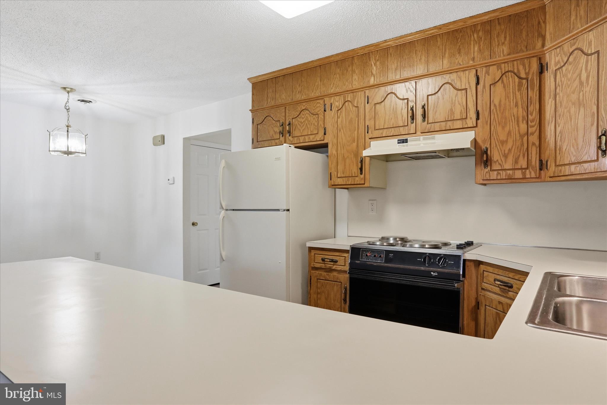 334 Stonegate Court Chambersburg, PA 17201 - Photo 7 of 25 a kitchen with stainless steel appliances a refrigerator a stove and white cabinets