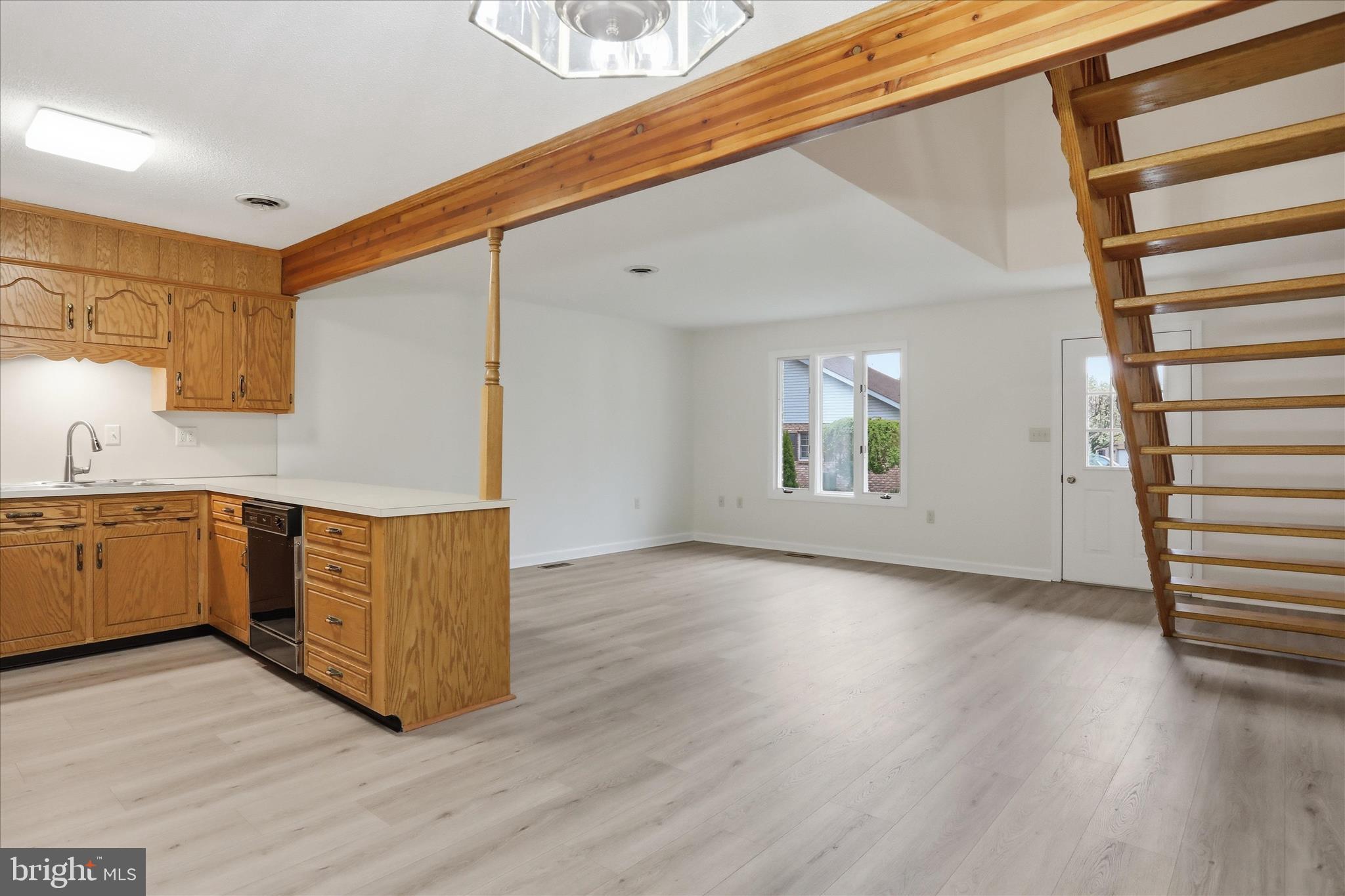334 Stonegate Court Chambersburg, PA 17201 - Photo 8 of 25 a kitchen with stainless steel appliances granite countertop a sink and wooden floors
