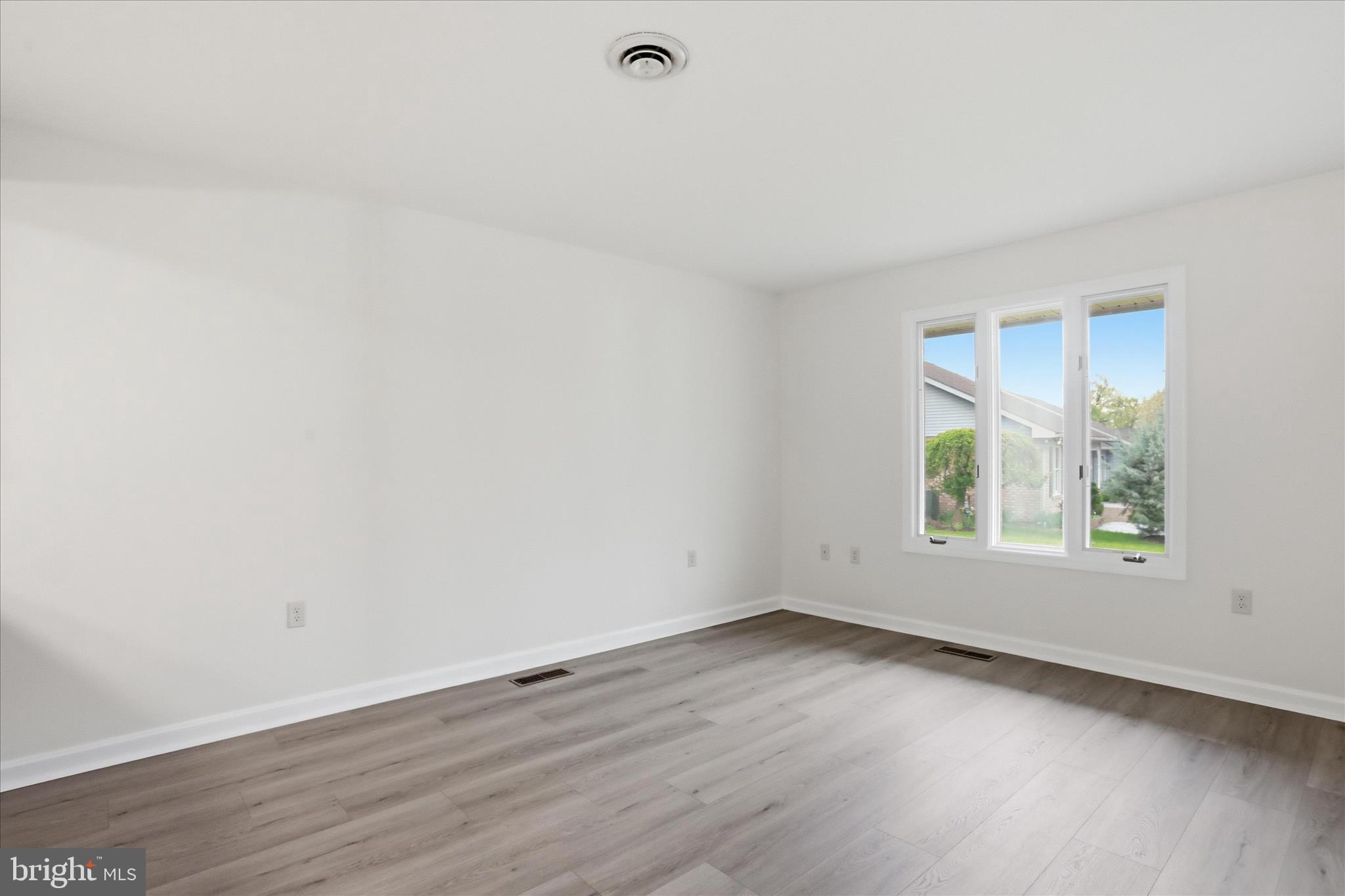 334 Stonegate Court Chambersburg, PA 17201 - Photo 9 of 25 an empty room with wooden floor and windows