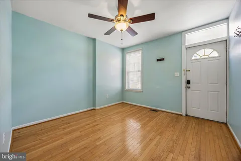 wooden floor in an empty room with a window