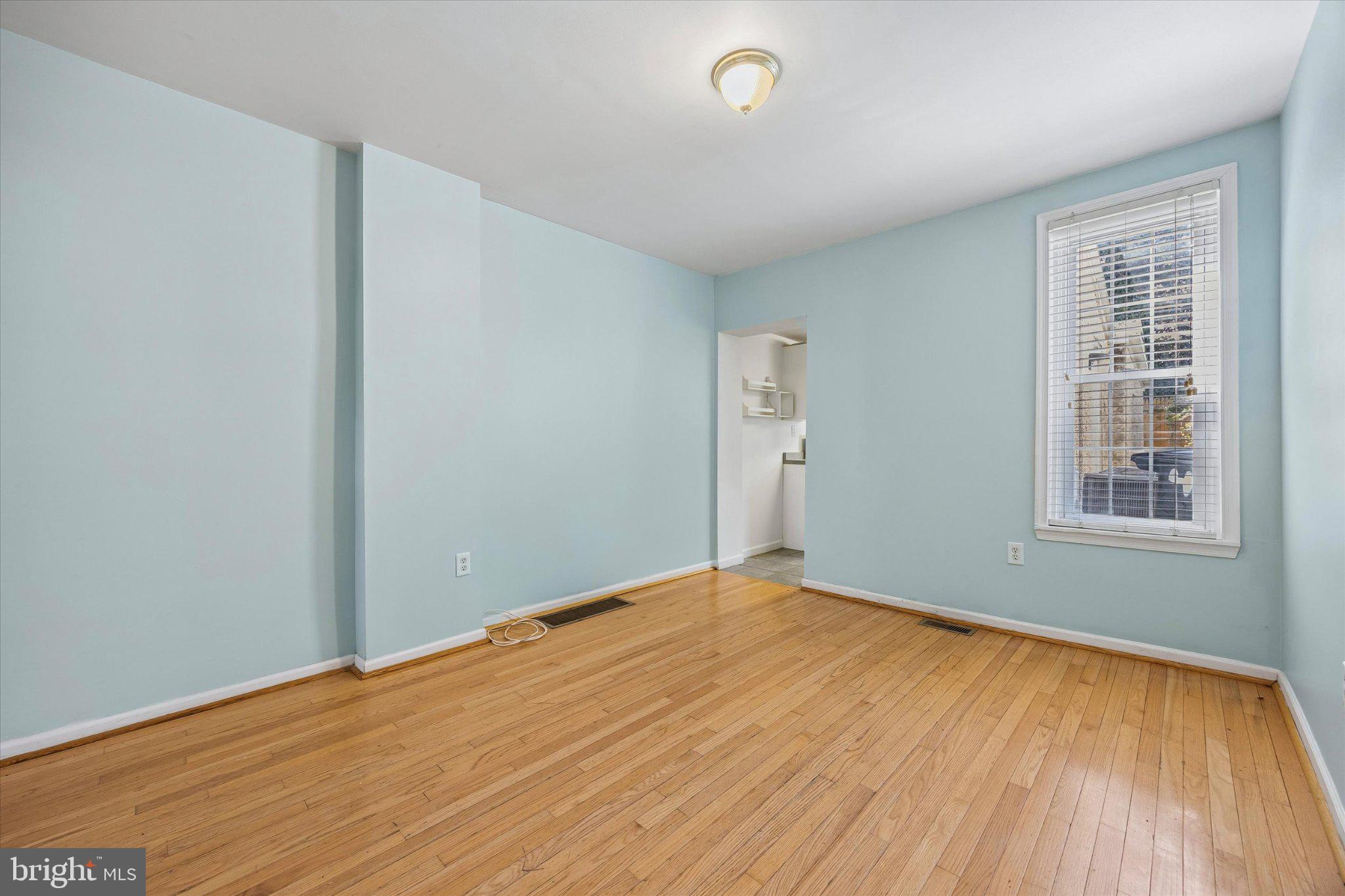 4334 Fleming Street Philadelphia, PA 19128 - Photo 7 of 25 an empty room with wooden floor and windows