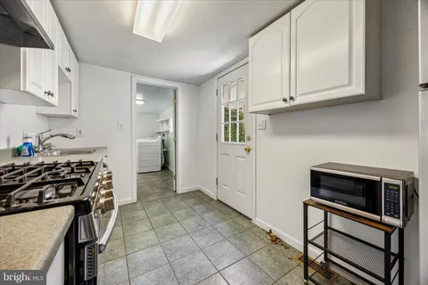 a kitchen with stainless steel appliances granite countertop a stove and a refrigerator