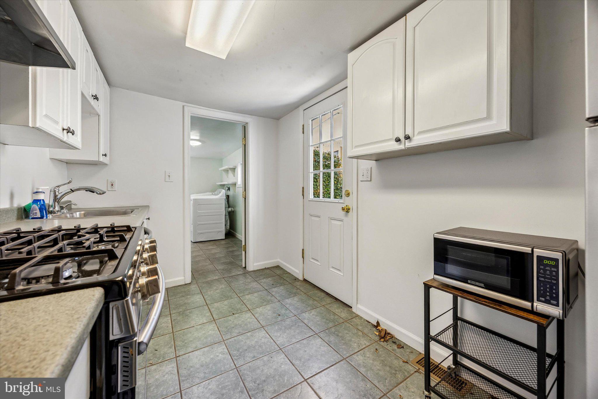 4334 Fleming Street Philadelphia, PA 19128 - Photo 9 of 25 a kitchen with stainless steel appliances granite countertop a stove and a refrigerator