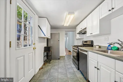 a kitchen with stainless steel appliances granite countertop a refrigerator and a stove